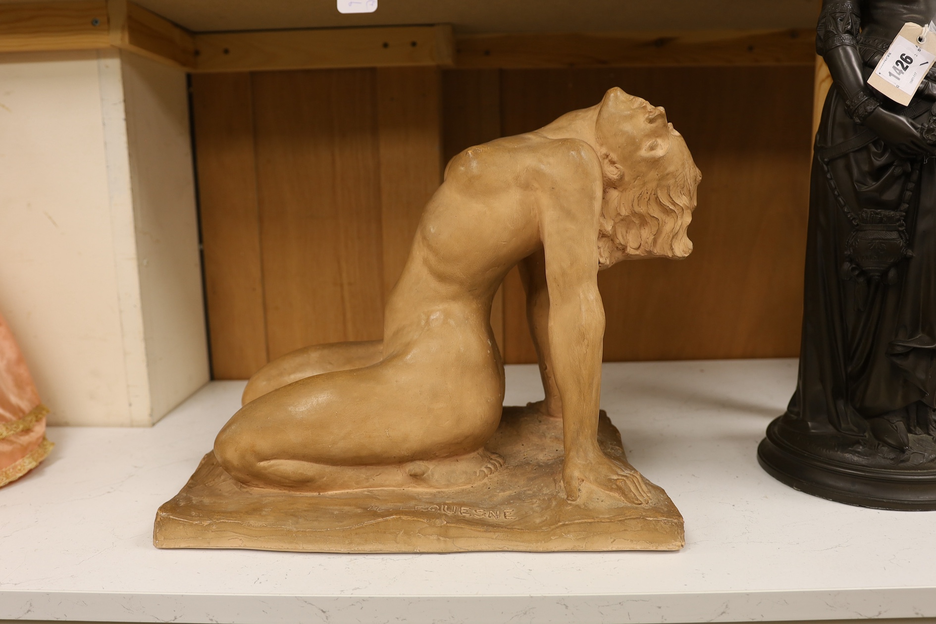 A French Art Deco terracotta semi reclining nude, stamped M. Lequesne, 36cm high. Condition - fair to good, slight scratches